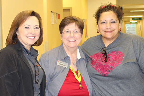 Entergy Texas President and CEO Sallie Rainer (left) visits with Senior Customer Service Specialist Paula Odom of Entergy Texas Public Affairs and Entergy customer Melissa Delgado.